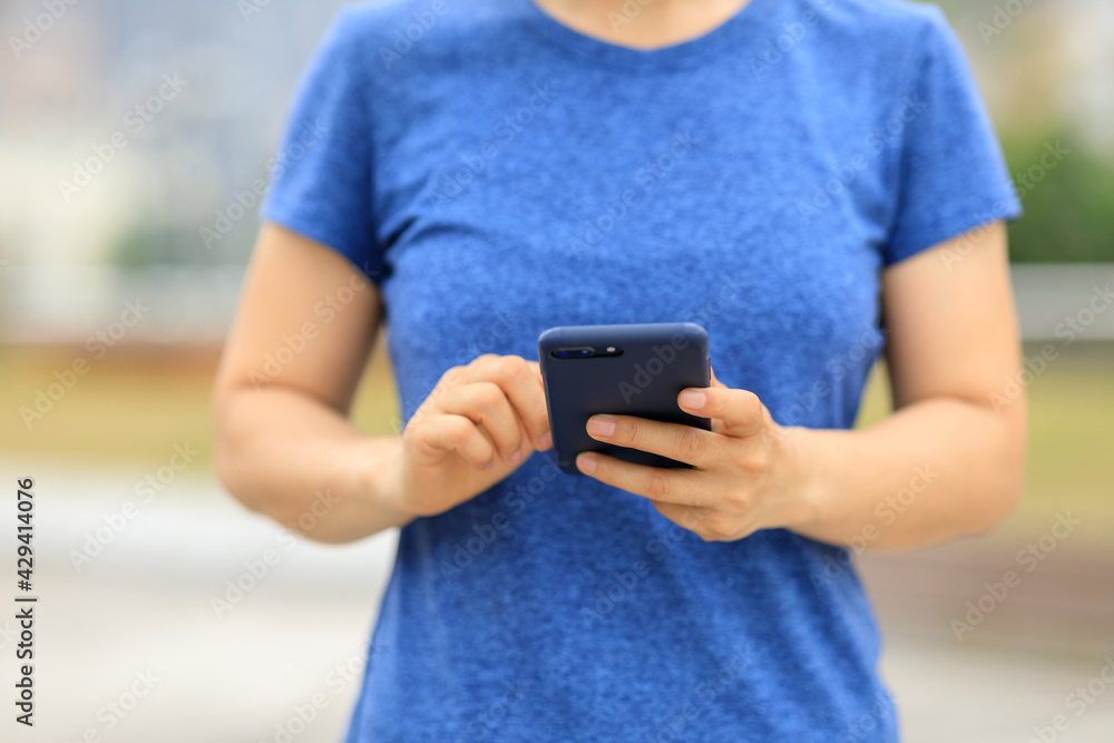 Asian woman using smartphone outdoors Asian woman using smartphone outdoors