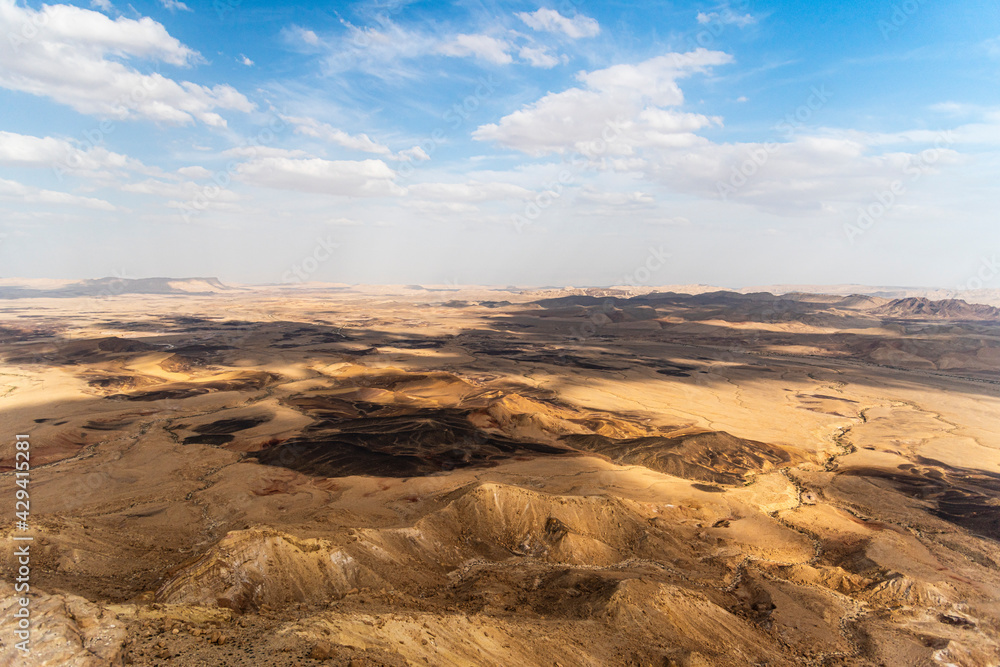 Ramon Crater Makhtesh Ramon, the largest in the world, as seen from the high rocky cliff edge surrounding it from the north, Ramon Nature reserve, Mitzpe Ramon, Negev desert, Israel. High quality