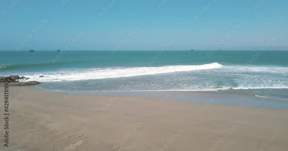Surfers waiting for big sea wave near Lobitos, Peru. Aerial backward Surfers waiting for big sea wave near Lobitos, Peru. Aerial backward