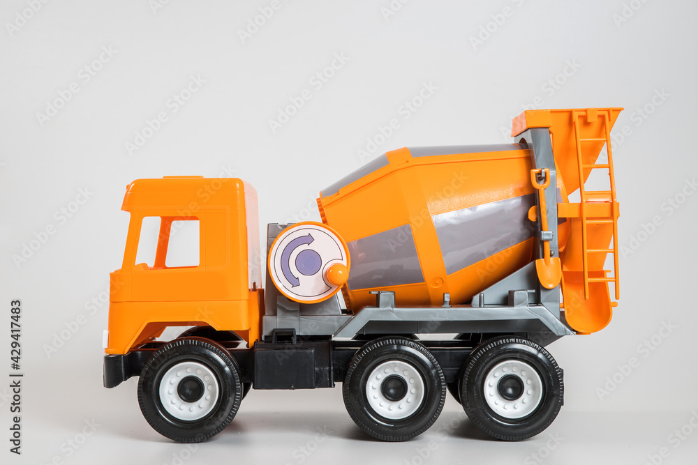 Multi-colored plastic children's toy cars on a white background. Orange concrete truck.