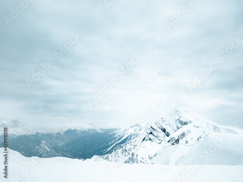 Snow-capped mountain peaks. Epic mountain landscape and dramatic sky.