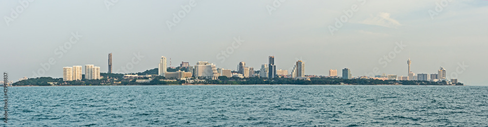 view from water of a Thailand city and the blue sea with sunlight