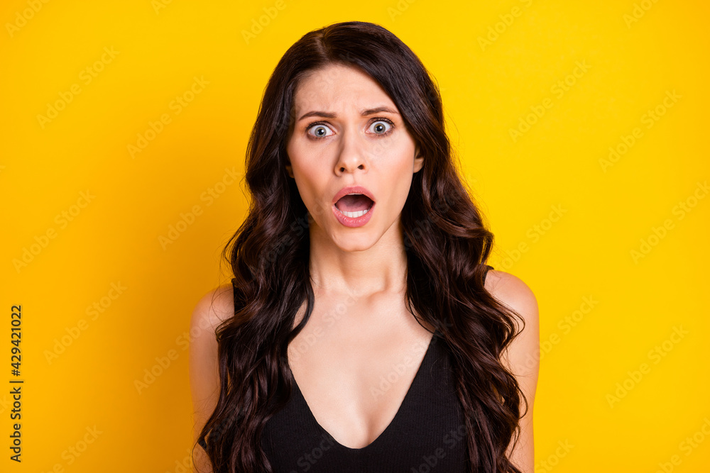 Photo of young girl amazed shocked surprised fake novelty news isolated over yellow color background Photo of young girl amazed shocked surprised fake novelty news isolated over yellow color background