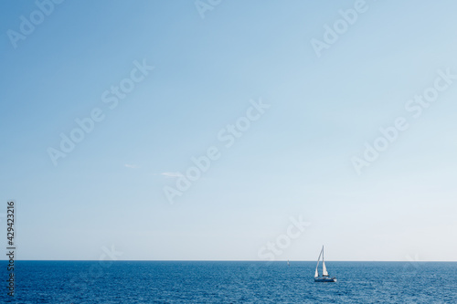 Sailing ship on the high seas against the blue sky