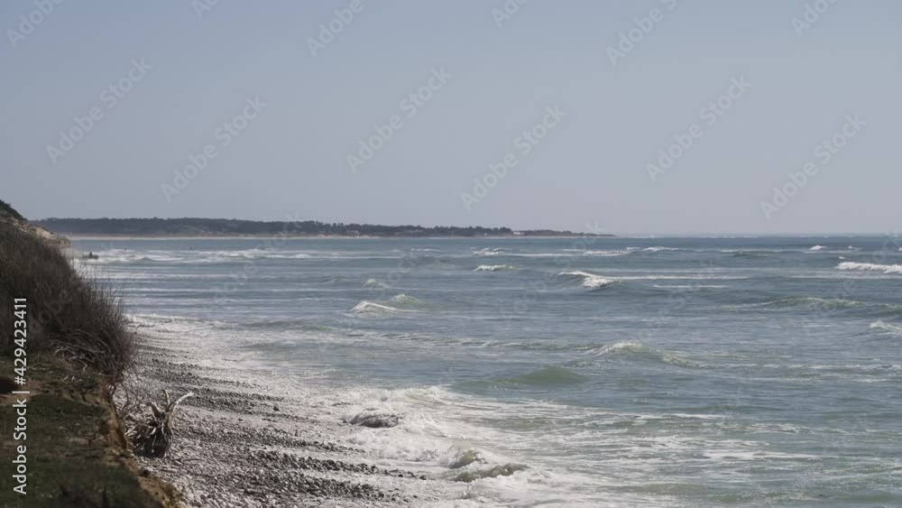 Pebbled seashore with mild waves at Oleron island in western France, Medium handheld shot Pebbled seashore with mild waves at Oleron island in western France, Medium handheld shot