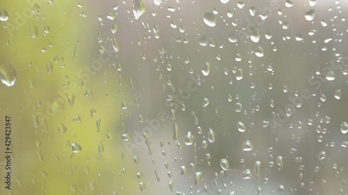 Window with rain drops on the glass in spring