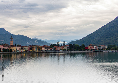Tableau sur toile View of Porlezza city during summer cloudy day evening over Lugano lake in Italy
