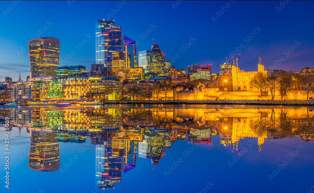 Fototapeta premium Tower of London and financial district of London reflected at dusk