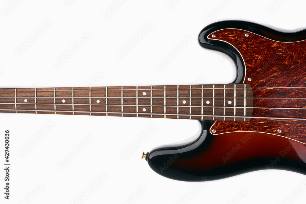 Obraz premium Metallic volume treble guitar bass knobs. Electric guitar. Red electric bass guitar close-up. Musical instrument. Music. Four strings. Grif.