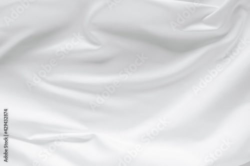 Abstract white fabric texture background. Cloth soft wave. Creases of satin, silk, and cotton.