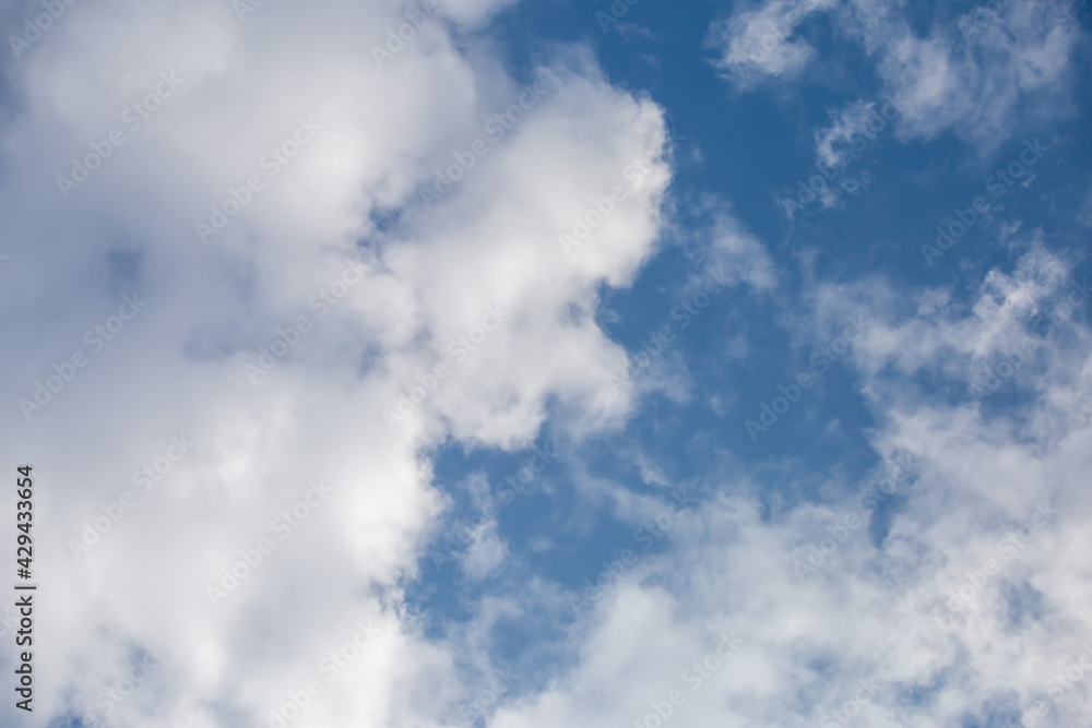 Soft white clouds in the close-up sky look dense, beautiful for background design, copy space available. Blue background