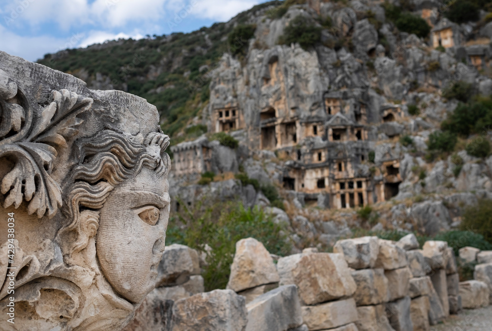 Ancient lycian Myra tombs and woman's stone face in Turkey, Demre