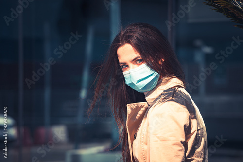 Girl with medical mask is staying in the city during pandemic of Coronavirus Covid-19