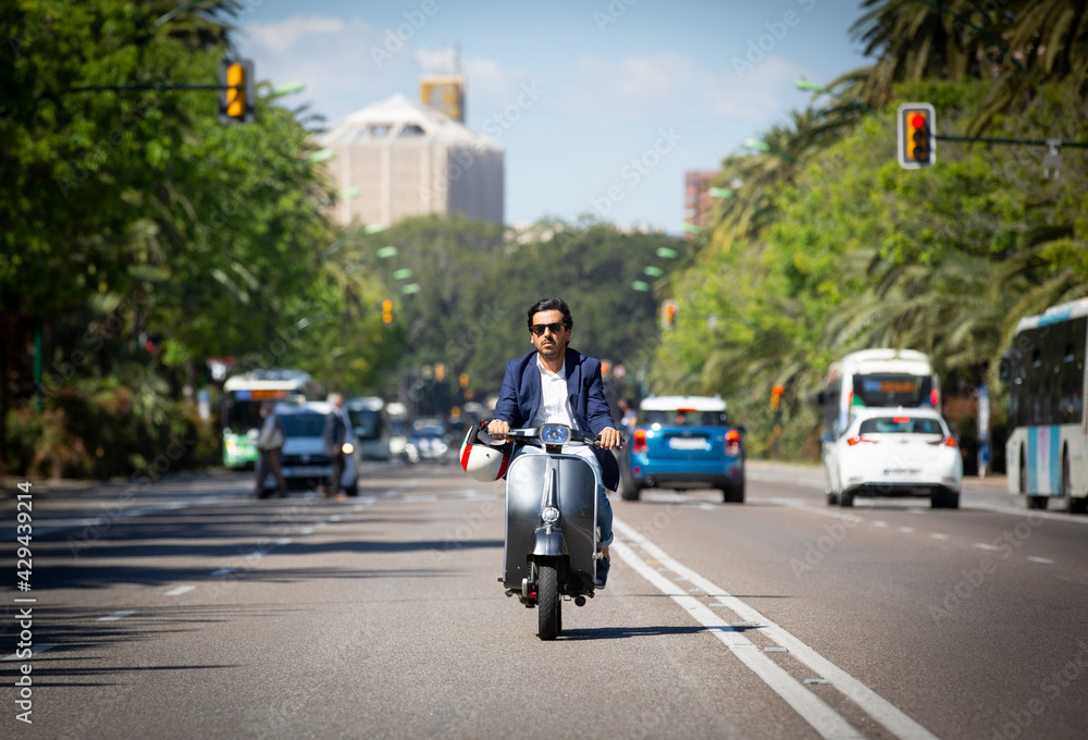 Young man driving a scooter