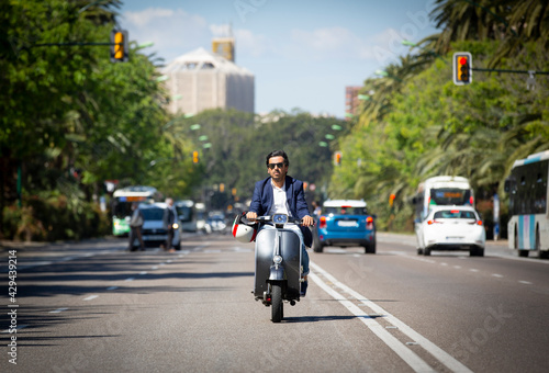 Young man driving a scooter