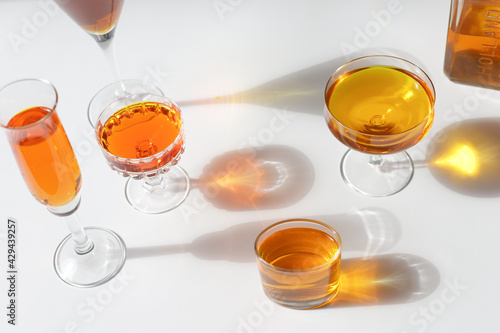 Reflections of glasses with orange drink and bottle with logo Holland to celebrate King's Day .