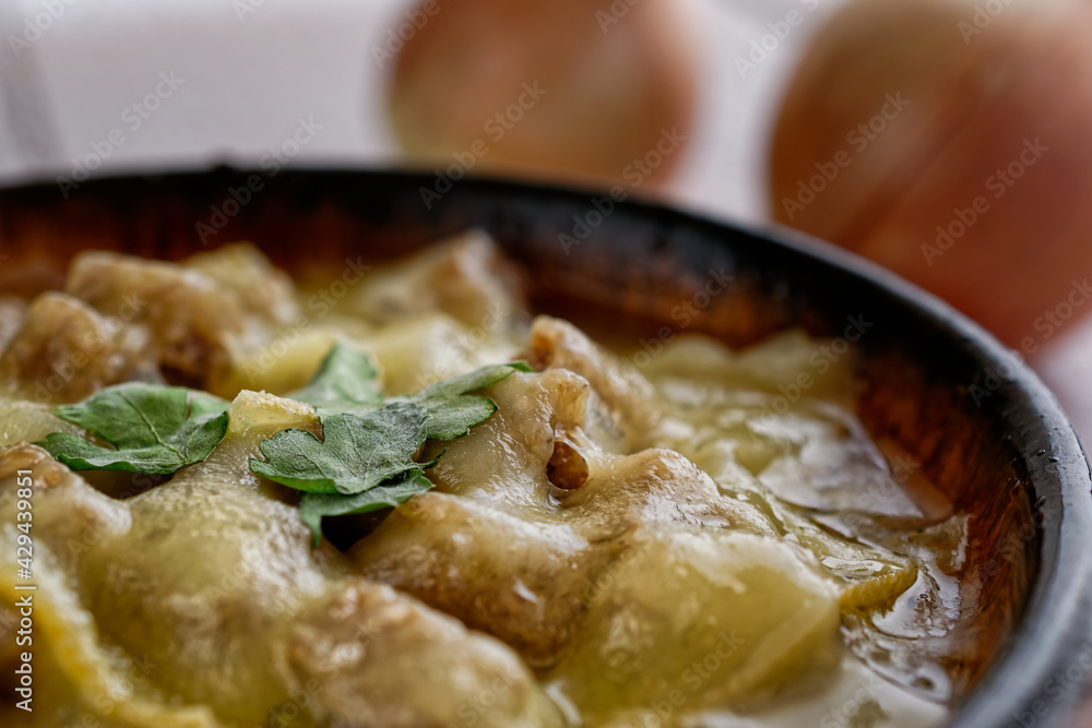 Close-up of a traditional onion soup, topped with croutons and cheese. Close-up of a traditional onion soup, topped with croutons and cheese.
