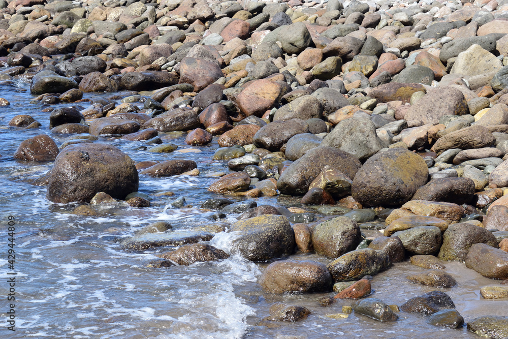 Waves Lapping Smooth Stones of Sunny Beach Waves Lapping Smooth Stones of Sunny Beach
