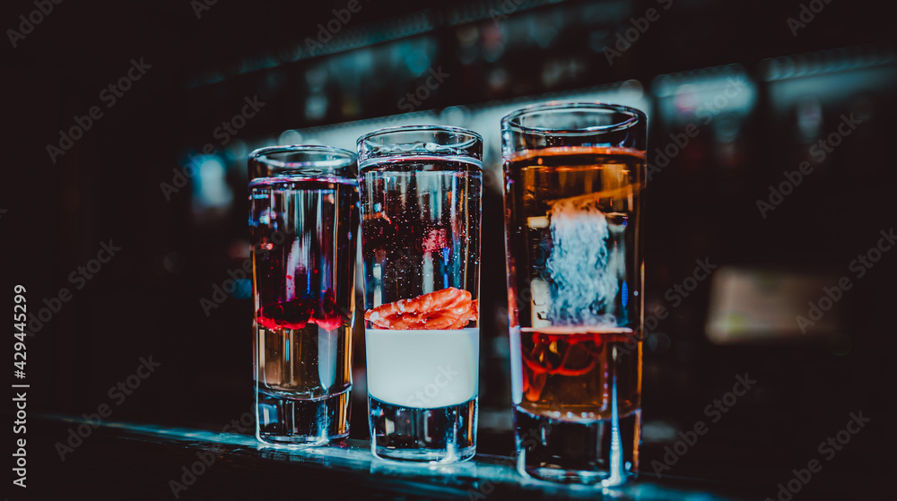 bartender making collection of colorful shots. Set of cocktails at the bar bartender making collection of colorful shots. Set of cocktails at the bar