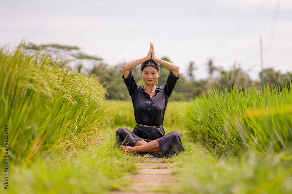 artistic portrait of young attractive and happy Asian woman outdoors at green rice field landscape dancing and doing yoga relaxation exercise and meditation
artistic portrait of young attractive and happy Asian woman outdoors at green rice field landscape dancing and doing yoga relaxation exercise and meditation