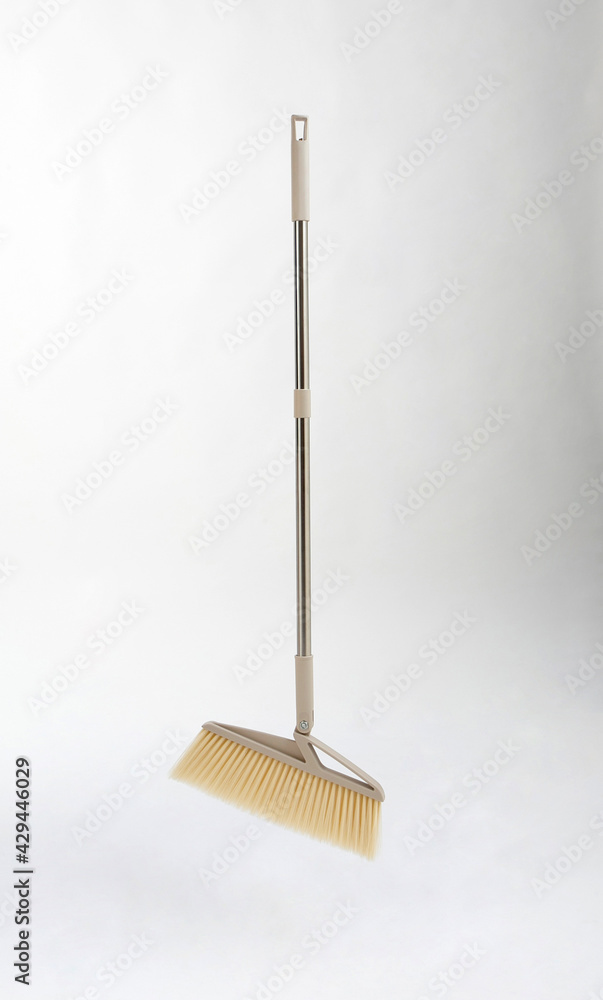 new broom with metal handle isolated on white new broom with metal handle isolated on white