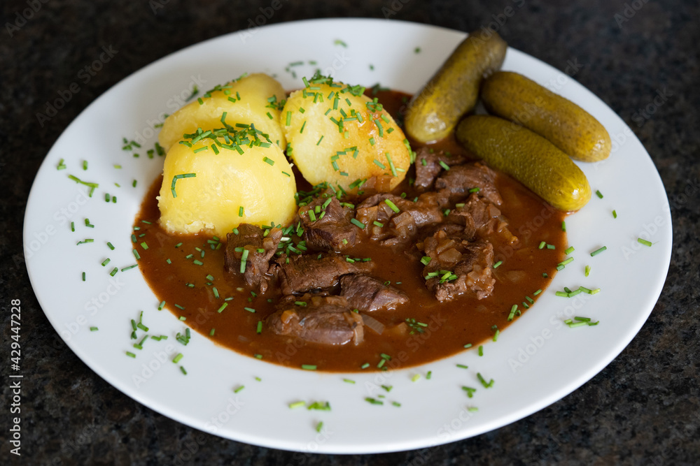 ready to eat - delicious goulash of wild with potatoes, pickles and chives ready to eat - delicious goulash of wild with potatoes, pickles and chives