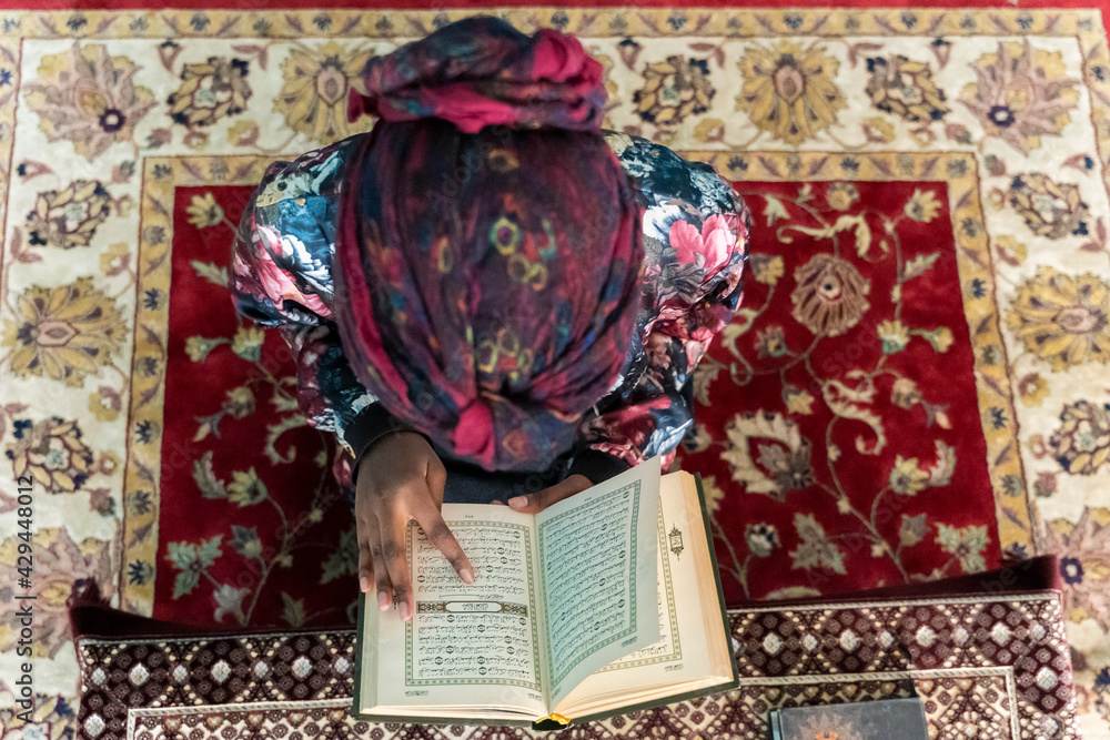 Black Muslim woman studying and reading Stock Photo | Adobe Stock