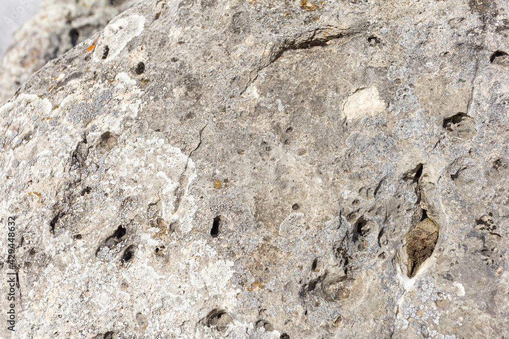 Natural mountain stone in a natural environment, rough surface burnt out in the sun and exposed to natural destruction. Natural mountain stone in a natural environment, rough surface burnt out in the sun and exposed to natural destruction.