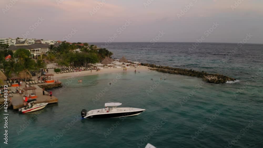 aerial image with drone on the beach Jan thiel with happy hour in the zamzibar on the island of Curaçao and a beautiful sunset aerial image with drone on the beach Jan thiel with happy hour in the zamzibar on the island of Curaçao and a beautiful sunset