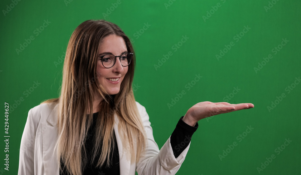 Young woman presents something on her palm - studio photography Young woman presents something on her palm - studio photography