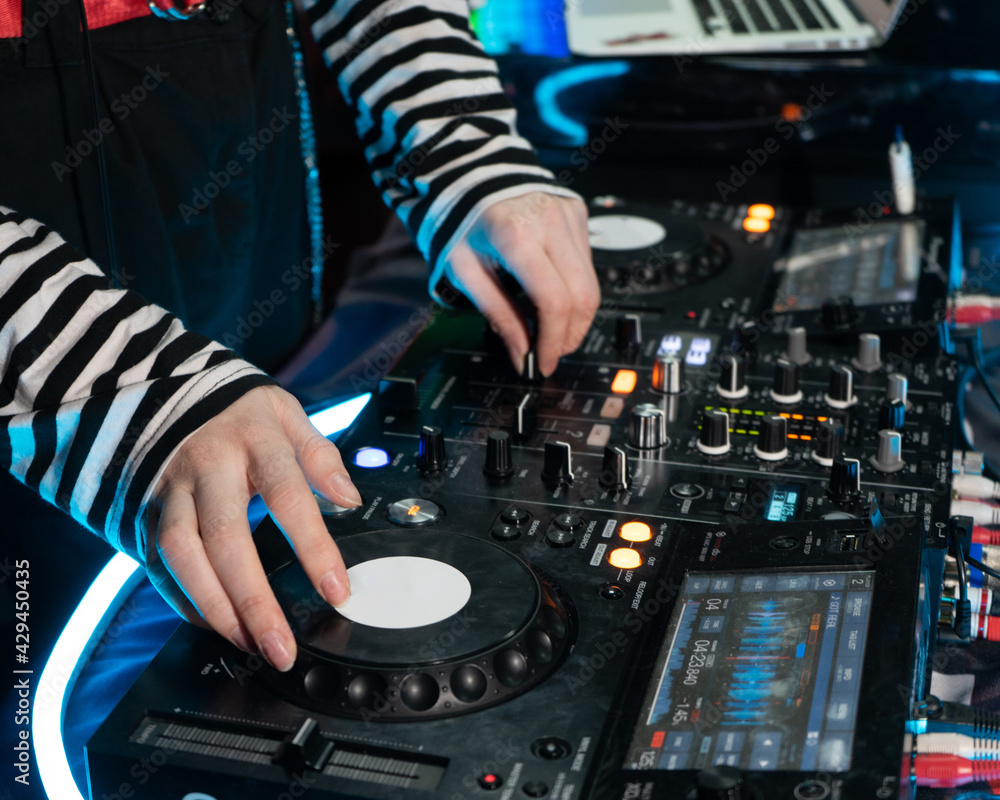 Obraz premium DJ sets up a mixing console, DJ equipment in front of him