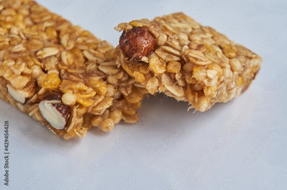 Two pieces of granola bar on white table Two pieces of granola bar on white table