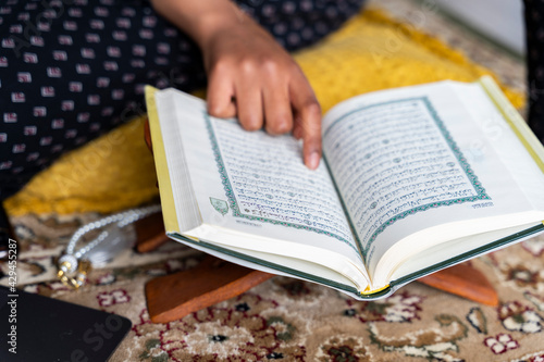 Black Muslim Woman studying quran