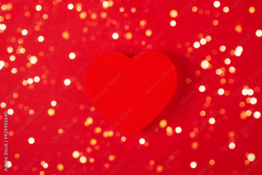 Red Heart shape gift box isolated on red background. Top view. Valentine's Day, birthday, wedding or party, anniversary, mothers day banner