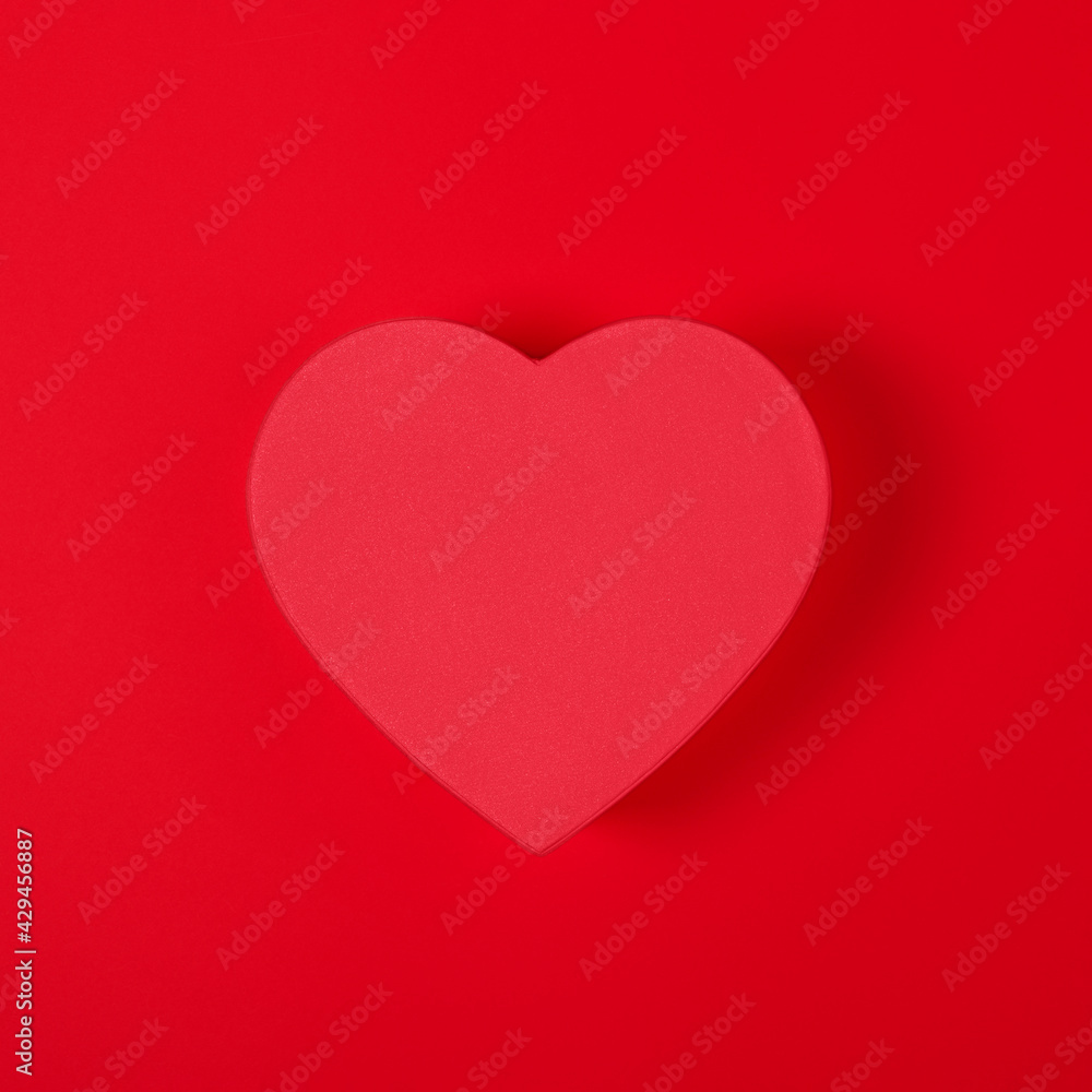 Minimal style Red Heart shape gift box isolated on red background banner. Top view. Valentine's Day, birthday, wedding or party, anniversary, mothers day banner