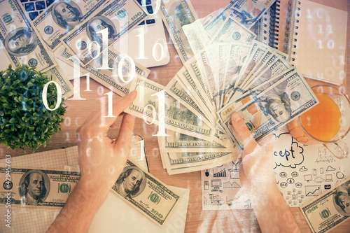 Multi exposure of technology drawing hologram and us dollars bills and man hands. Data concept