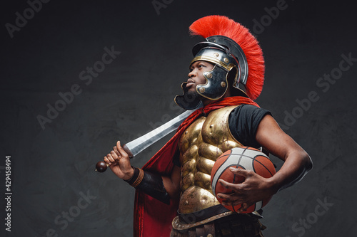 Black sportsman with basketball in legionary costume