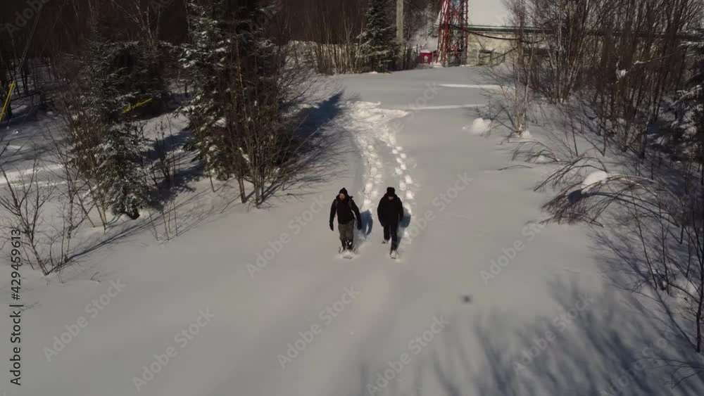 Adventurous video taken by a drone camera, featuring two young explorers making documentary of telecommunication signal towers, surrounded by snow Adventurous video taken by a drone camera, featuring two young explorers making documentary of telecommunication signal towers, surrounded by snow