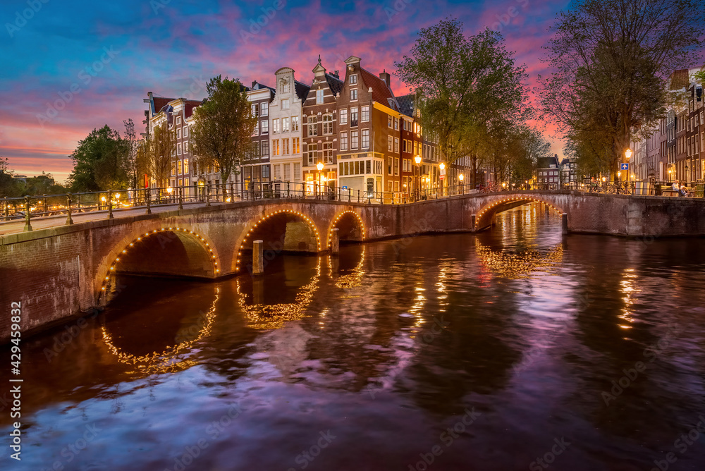 Holland, Amsterdam - April 20, 2021 - The Keizersgracht canal in Amsterdam at dusk.