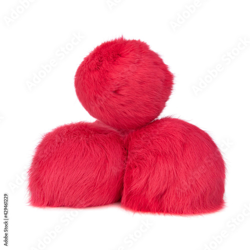 Close up of hot pink rabbit fur pompoms isolated on white background. 