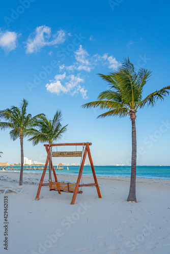 Beach with a empty swing at the morning in cancun