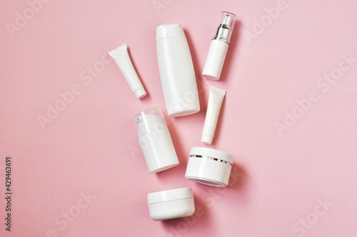 Various cosmetic products on a pink background. Advertising model. Copy space. Flat lay. Cosmetics skin care.