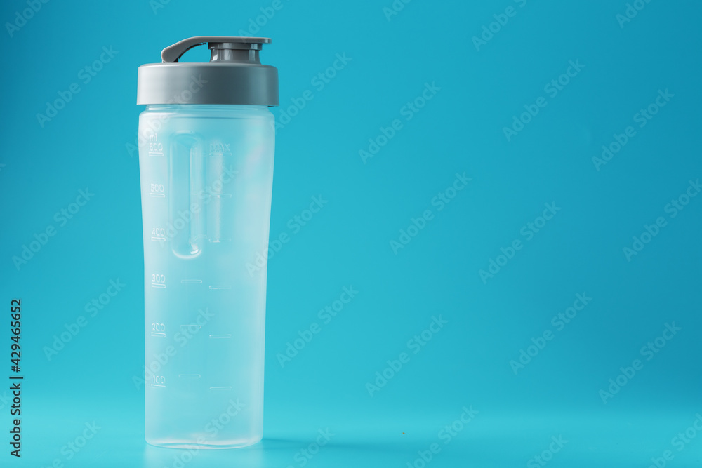 Shaker is an empty plastic smoothie cup on a blue background. Shaker is an empty plastic smoothie cup on a blue background.
