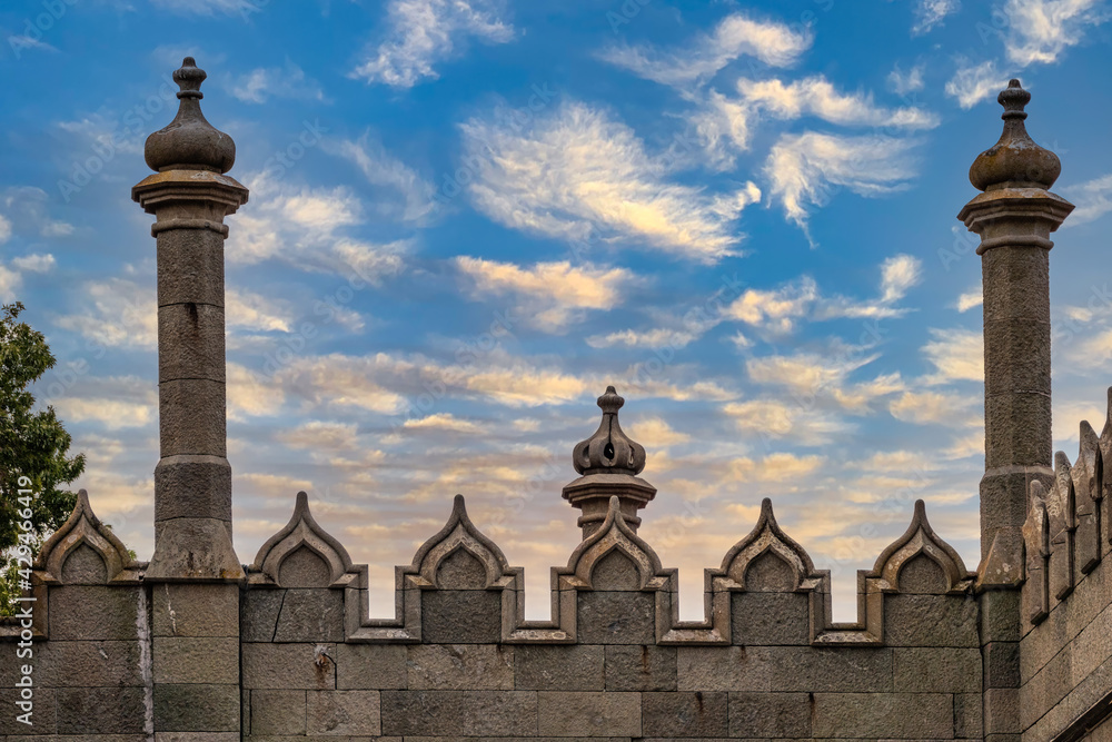 The walls and towers of the old palace on the background of a blue sky