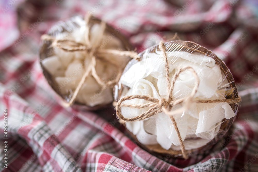 Coconut dried candies stored in coconut shells decor with rope Coconut dried candies stored in coconut shells decor with rope