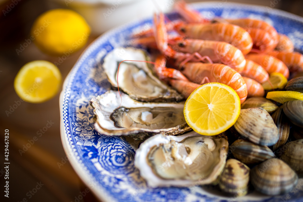 Seafood (langoustines, oysters and clams) on plate Seafood (langoustines, oysters and clams) on plate