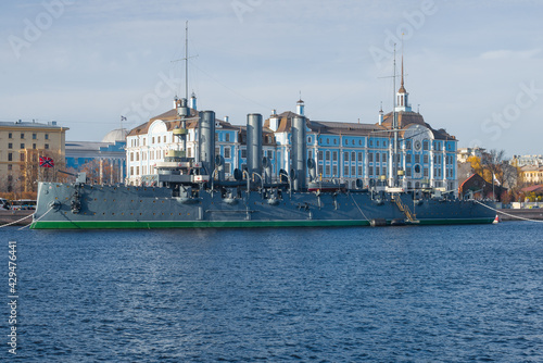 Old Cruiser "Aurora" against the background of the building of the Nakhimov Naval School on October afternoon, Saint Petersburg