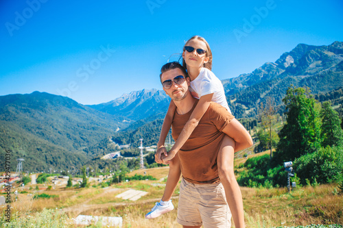 Beautiful happy family in mountains in the background of fog