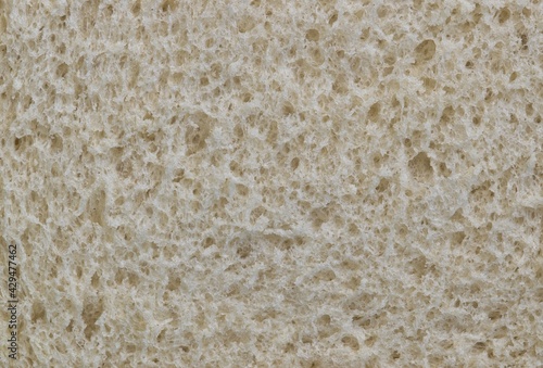 White bread texture, closeup slice with macro surface details. One of mankind's oldest staple foods.