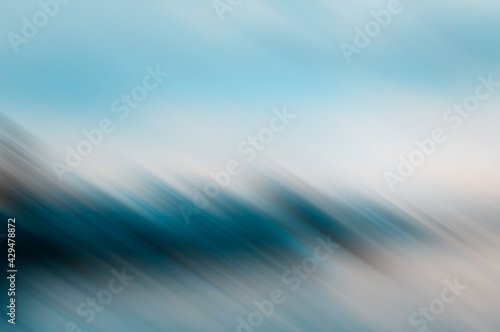 Blurred abstract background for design in turquoise and blue colors. Motion effect. © natavilman